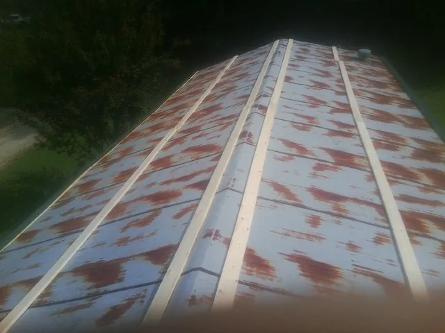 Rusted metal roof panels with new wood purlins before replacement — Storm Damage Roof Repair in Lodge by Roofing Brothers